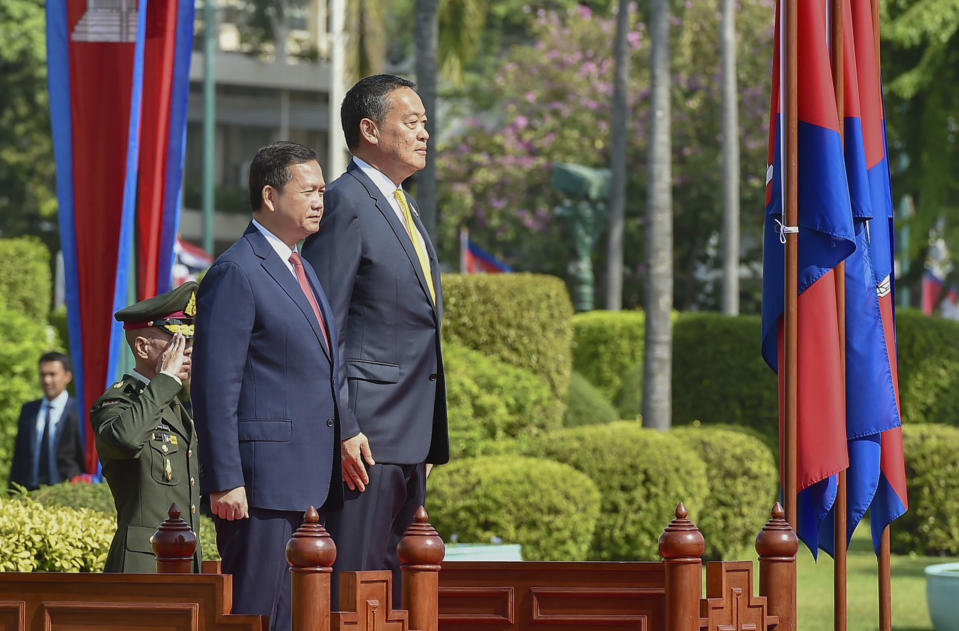In this photo released by the government spokesman office, Cambodia's Prime Minister Hun Manet, front, escorted by Thailand's Prime Minister Srettha Thavisin, listens to national anthems during a welcoming ceremony at the Government House in Bangkok, Thailand, Wednesday, Feb. 7, 2024. (Government Spokesman Office via AP)
