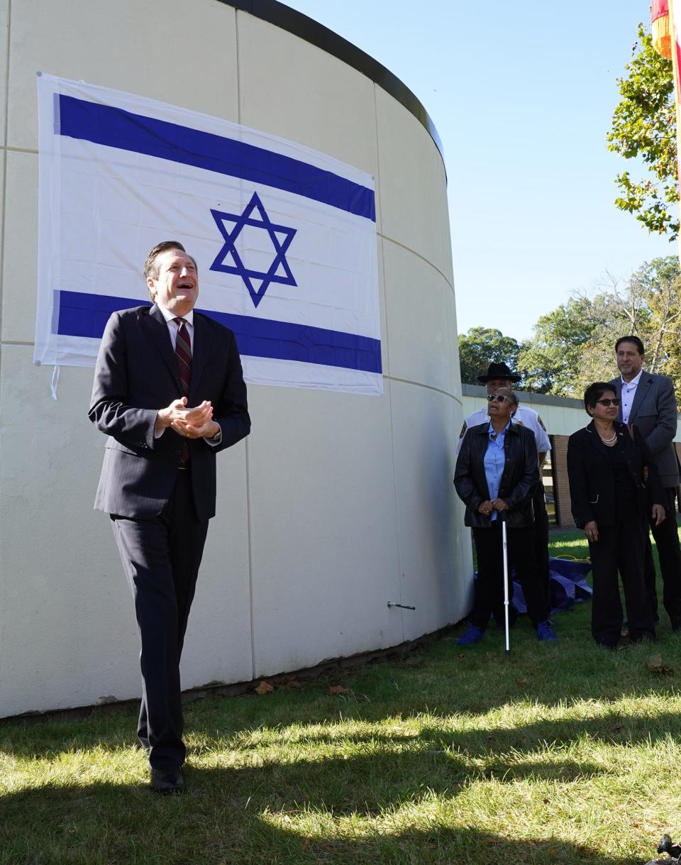 Ramapo Supervisor Michael Specht offers remarks as the flag of Israel is affixed on the front of the Ramapo Town Hall in Airmont after a ceremony on Thursday, October 12, 2023.