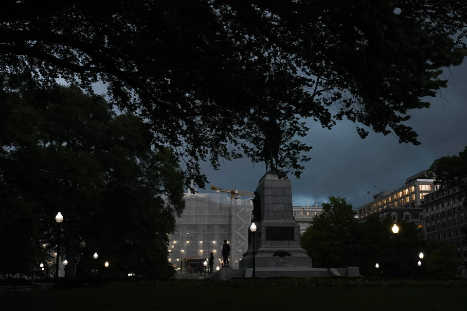 Storm clouds darken the sky over the Treasury Department, center, Monday, Aug. 7, 2023, in Washington. Thousands of federal employees were sent home early Monday as the Washington area faced a looming forecast for destructively strong storms, including tornadoes, hail and lightning. (AP Photo/Jacquelyn Martin)