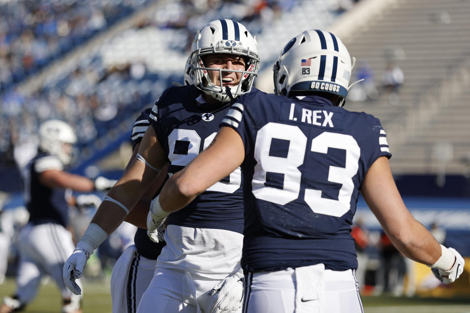 BYU tight end Carter Wheat, left, congratulates tight end Isaac Rex (83) for his touchdown in the first quarter against North Alabama during an NCAA college football game Saturday, Nov. 21, 2020, in Provo, Utah. (AP Photo/Jeff Swinger, Pool)