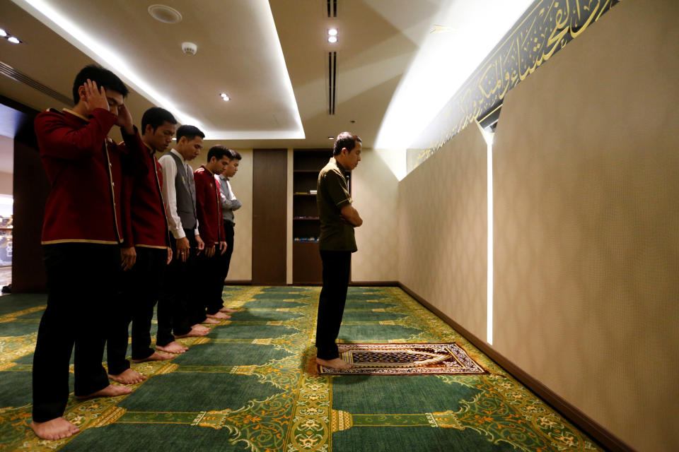 Muslim employees pray at the Al Meroz hotel in Bangkok