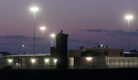 FILE PHOTO: The federal penitentiary is seen after sunset in Terre Haute, Indiana June 10, 2001. REUTERS/Andy Clark/File Photo