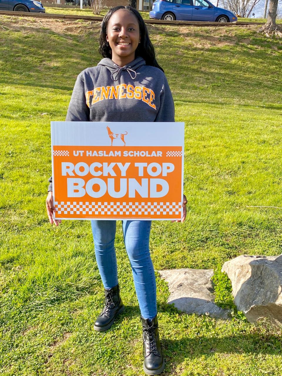 Clearly “all Vol,” Jahneulie Weste beams as she shows off her Haslam Scholar sign. She’s one of 15 outstanding high school seniors chosen to receive the scholarship. May 2022