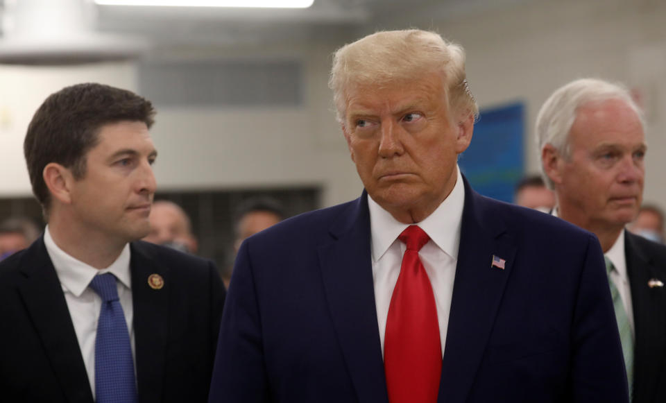 U.S. President Donald Trump is accopmpanied by U.S. Rep. Bryan Steil (R-WI) and Senator Ron Johnson (R-WI) during a visit to Mary D. Bradford High School after surveying damage in the aftermath of recent protests against police brutality and racial injustice, and the ensuing violence after the shooting of Jacob Blake by a police officer in Kenosha, Wisconsin, U.S., September 1, 2020. REUTERS/Leah Millis?