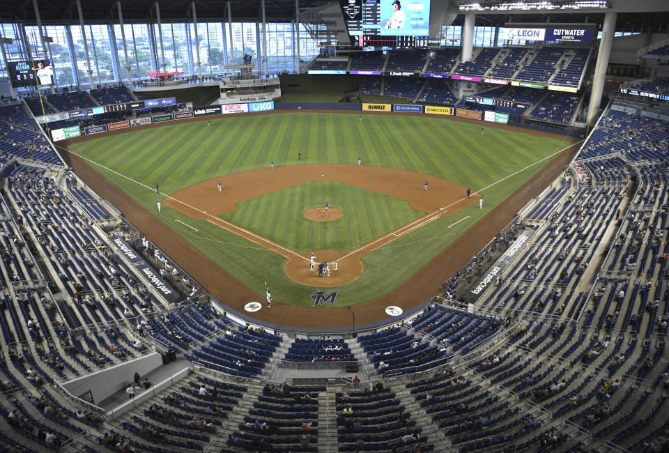 The Miami Marlins and the Tampa Bay Rays play during the second inning of a baseball game on opening day, Thursday, April 1, 2021, in Miami. (AP Photo/Gaston De Cardenas)