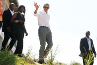 <p>Former U.S. President Barack Obama waves to photographers as he tours the Sauti Kuu resource centre near his ancestral home in Nyangoma Kogelo village in Siaya county, western Kenya July 16, 2018. With him is Auma Obama. (Photo: Thomas Mukoya/Reuters) </p>