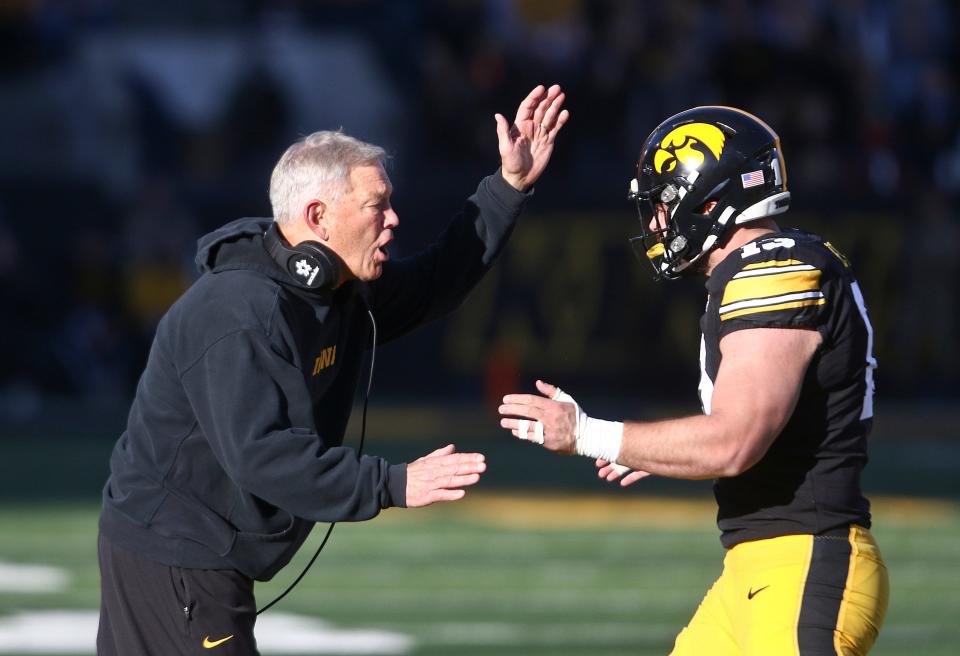 Head coach Kirk Ferentz of the Iowa Hawkeyes congratulates defensive end Joe Evans (13) after a safety during the first half against the Illinois Fighting Illini. (Photo by Matthew Holst/Getty Images)