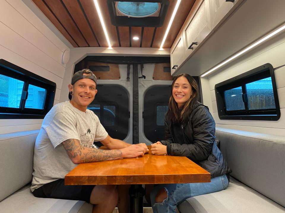 Danny and Kelley Diatchenko from VaVaVans show off some of their custom camper work in this Aug. 18 photo. In this full build they did, the dining table and seating area converts into a bed for the owner.