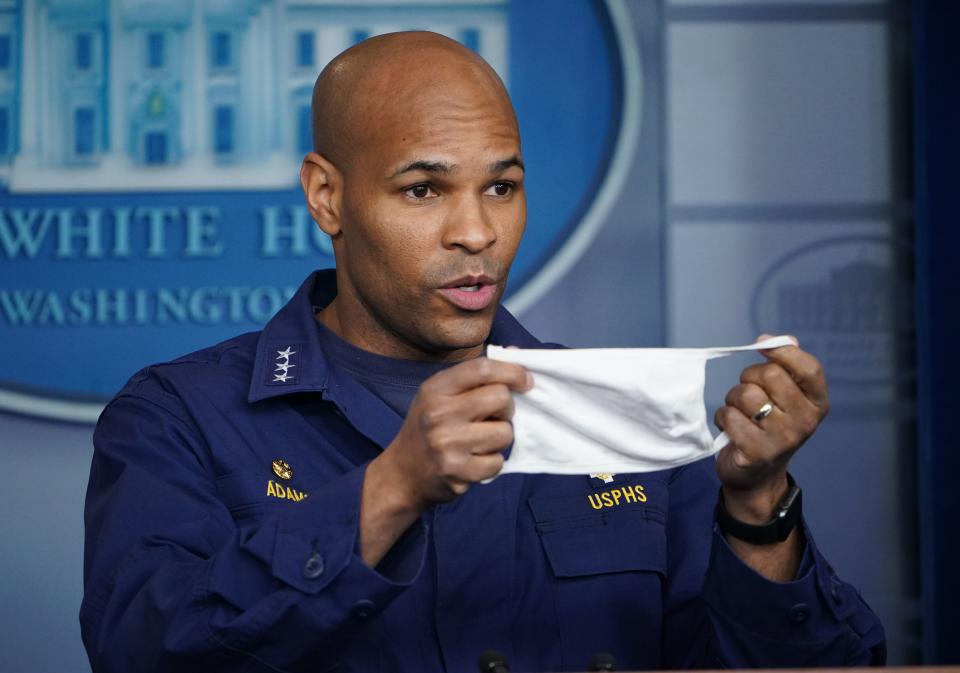 US Surgeon General Jerome Adams holds a face mask during the daily briefing on the novel coronavirus, which causes COVID-19, in the Brady Briefing Room of the White House on April 22, 2020, in Washington, DC. (Photo by MANDEL NGAN / AFP) (Photo by MANDEL NGAN/AFP via Getty Images)