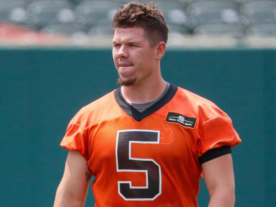 Logan Woodside walks on the field at Bengals training camp in 2018.