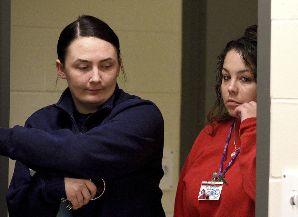 Kayla Montgomery enters the parole board hearing room at the New Hampshire Correctional Facility for Women in Concord, N.H., on Thursday, March 7, 2024. Kayla Montgomery, the estranged wife of Adam Montgomery, convicted of killing his 5-year-old daughter and moving the body around for months, has been granted parole more than a year after she was sentenced to prison for lying about where she was when the child was last seen. (David Lane/Union Leader via AP, Pool)