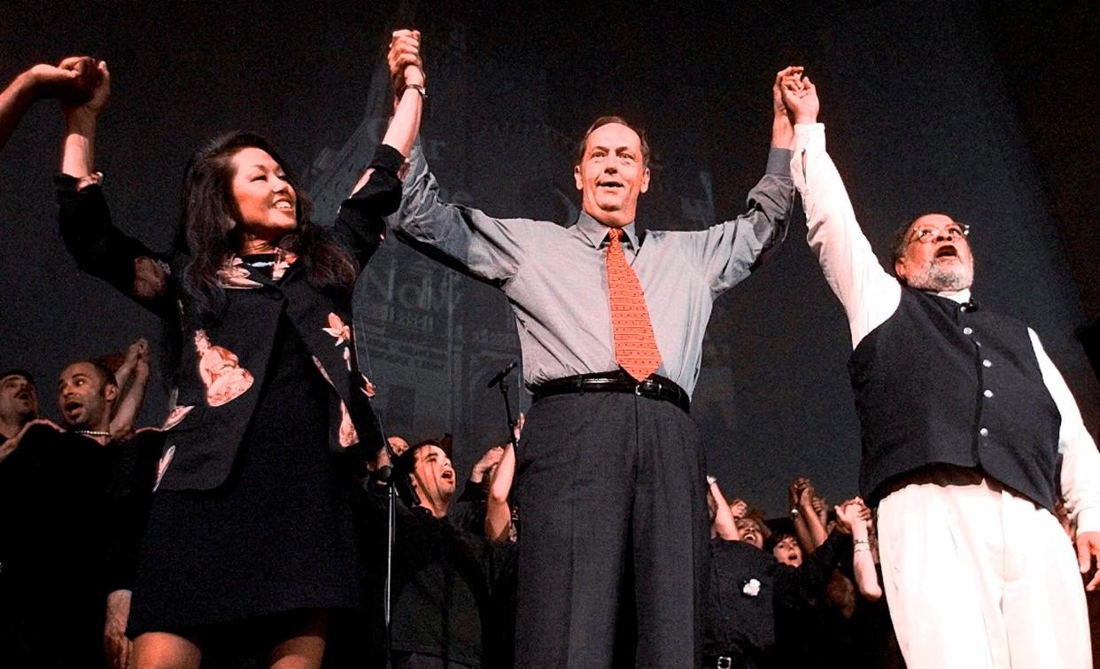 In this June 20, 1999 file photo, Janice Mirikitani, left, joins hands with Bill Bradley, center, and the Rev. Cecil Williams during services at Glide Memorial United Methodist Church in San Francisco.