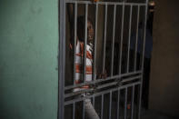 A boy displaced from his Croix-des-Missions home to avoid clashes between armed gangs, takes refuge in a school converted into a shelter in the Tabarre neighborhood of Port-au-Prince, Haiti, Thursday, April 28, 2022. The ongoing violence and kidnappings have prompted hundreds of Haitians to flee their country, often a deadly move. Dozens of have died at sea in recent months. (AP Photo/Odelyn Joseph)