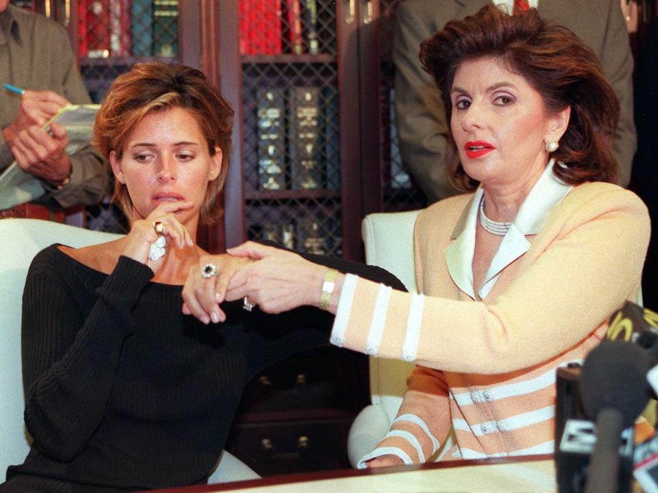 Kelly Fisher and her lawyer, Gloria Allred, at a press conference in Beverly Hills in 1997 (AFP via Getty Images)