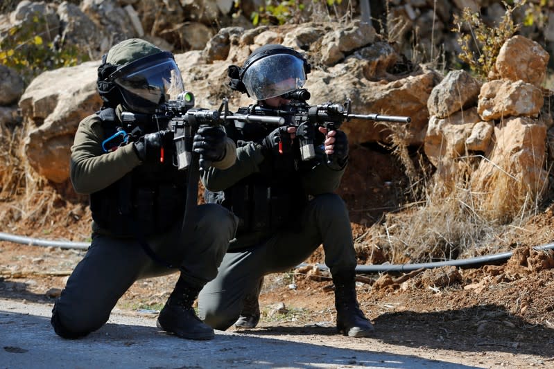 Israeli border policemen aim their weapons during a protest against the demolition of under-construction Palestinian houses by Israeli forces near Hebron in the Israeli-occupied West Bank