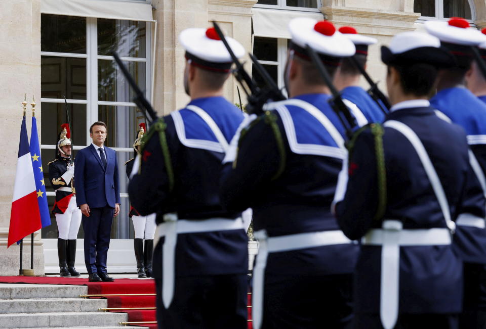 French President Emmanuel Macron reviews military troops during the ceremony of his inauguration for a second term at the Elysee palace, in Paris, France, Saturday, May 7, 2022. Macron was reelected for five years on April 24 in an election runoff that saw him won over far-right rival Marine Le Pen. (Gonzalo Fuentes/Pool via AP)