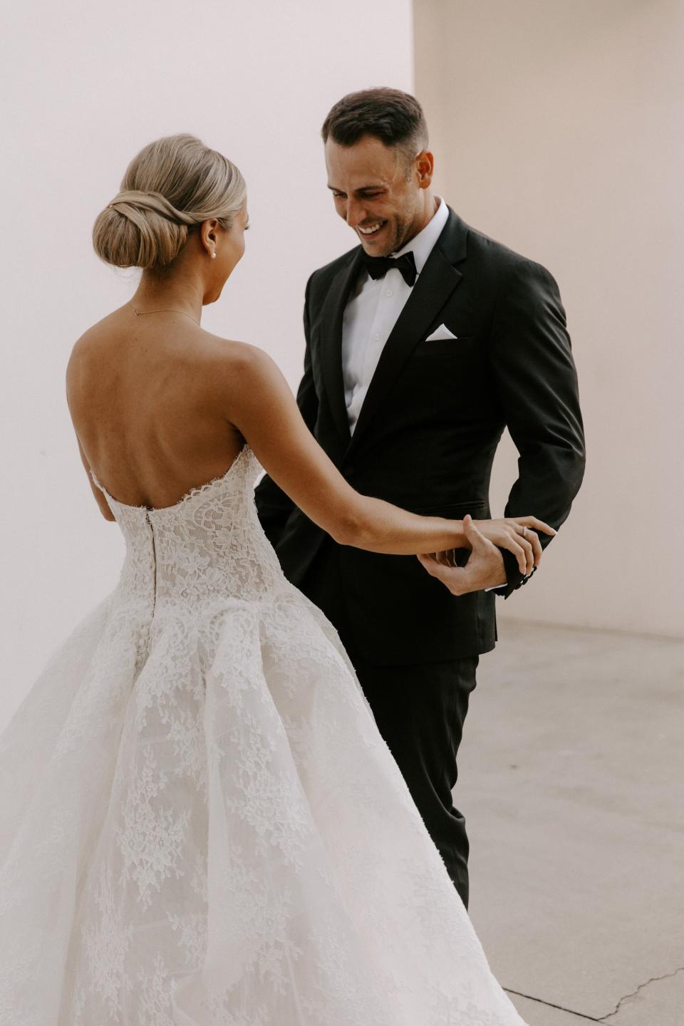 A groom looks at his bride during their first look.