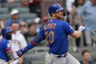 New York Mets first baseman Pete Alonso (20) follows through on a base hit in the first inning of a baseball game against the Atlanta Braves, Monday, May 17, 2021, in Atlanta. (AP Photo/John Bazemore)