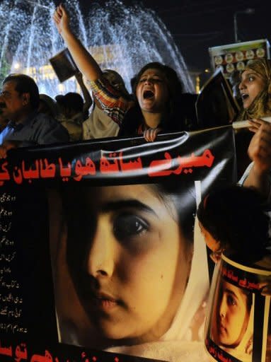 Pakistani civil society activists carry placards with photographs of gunshot victim Malala Yousafzai during a protest rally against her assassination attempt, in Lahore. International outrage grew Thursday at the shooting of a teenage Pakistani campaigner by the Taliban, with US President Barack Obama leading condemnation of the "disgusting" attack