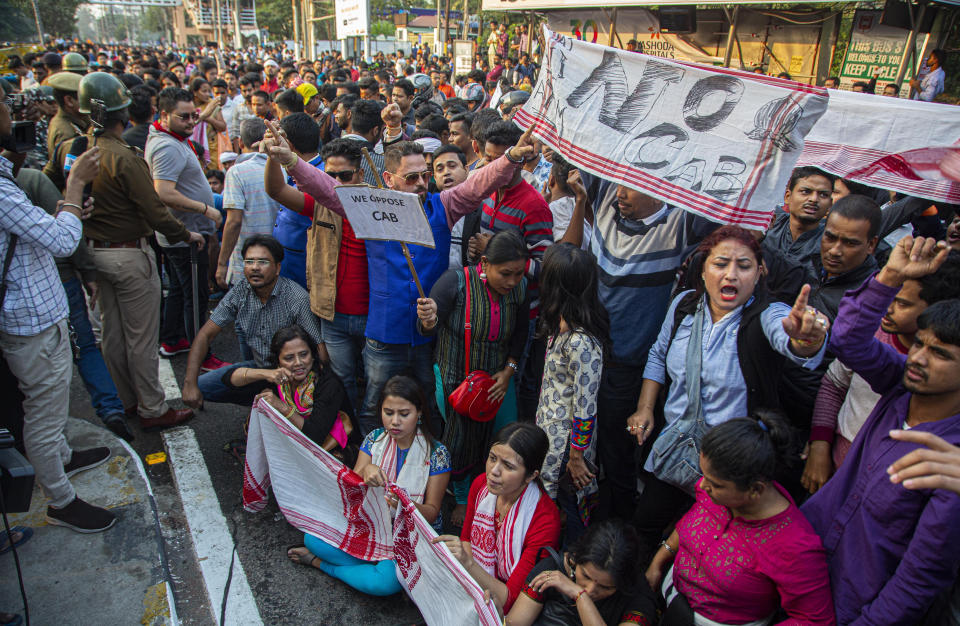 Protesters shout slogans against the Citizenship Amendment Bill (CAB) in Gauhati, India, Wednesday, Dec. 11, 2019. Protesters burned tires and blocked highways and rail tracks in India's remote northeast for a second day Wednesday as the upper house of Parliament began debating legislation that would grant citizenship to persecuted Hindus and other religious minorities from Pakistan, Bangladesh and Afghanistan. (AP Photo/Anupam Nath)