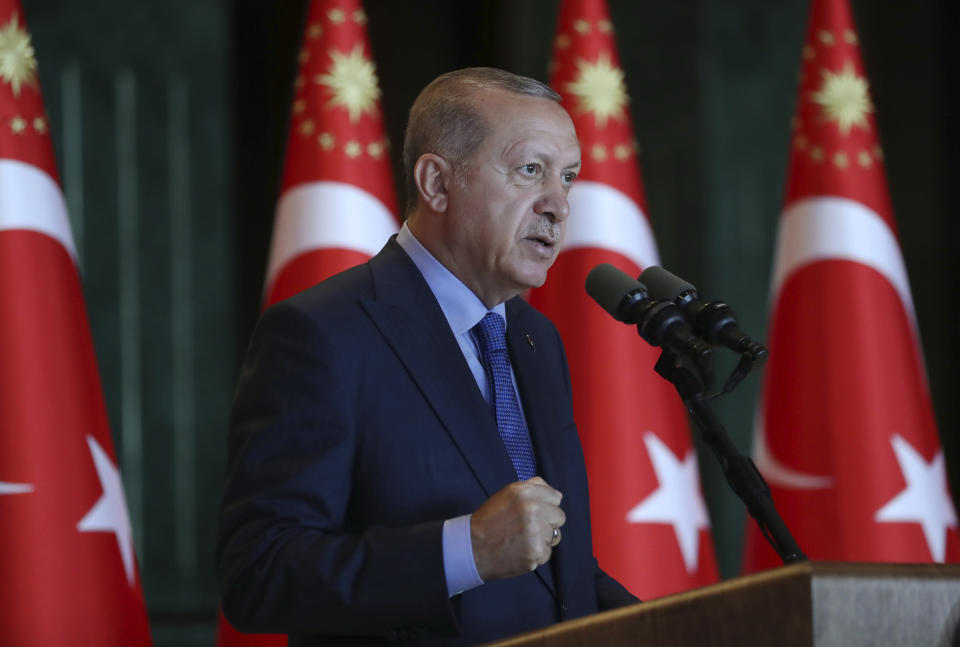 Turkey's President Recep Tayyip Erdogan, gestures as he delivers a speech to Turkish ambassadors at the Presidential Palace in Turkey, Monday, Aug. 13, 2018. Erdogan says his country is under an economic "siege" that has nothing to do with its economic indicators. He insisted that Turkey's economic dynamic remain strong and said the Turkish currency would soon settle "at the most reasonable level." (Pool Photo via AP)