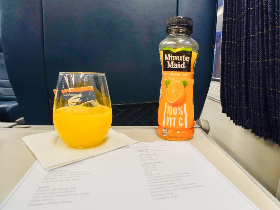 Beverages on a tray table on Amtrak Acela First class car