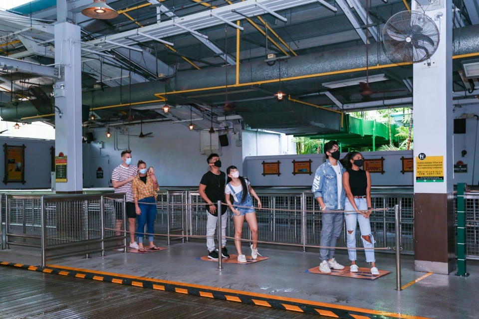 A posed photo of Universal Studios Singapore guests queueing for a ride with safe distancing of one-metre spacings. Resorts World Singapore attractions on Sentosa, including Universal Studios Singapore and the S.E.A. Aquarium, will reopen in Phase 2 of Singapore's reopening during the COVID-19 pandemic. (Photo: RWS)