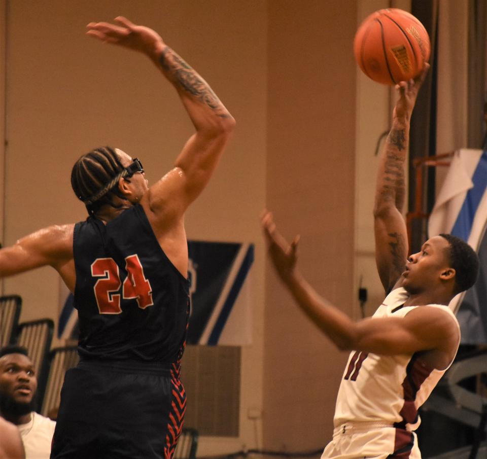 Sandhills Community College Flyer Jordan Coleman (right) puts up a shot with Darnell Askew (24) trying to block it for Brookdale Community College during the NJCAA's 2023 Division III men's basketball championship game. Both teams a returning to Herkimer College for the 2024 tournament and Askew, an all-tournament pick as a freshman, is the nation's No. 6 shot blocker for top-ranked Brookdale.