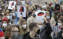 Women's rights activists with posters of the Women's Strike action protest in Warsaw, Poland, Wednesday, Oct. 28, 2020 against recent tightening of Poland's restrictive abortion law. Massive nationwide protests have been held ever since a top court ruled Thursday that abortions due to fetal congenital defects are unconstitutional. (AP Photo/Czarek Sokolowski)