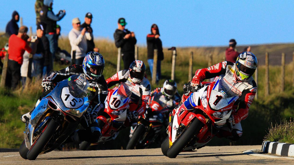  Riders taking a corner at the Isle of Man TT 