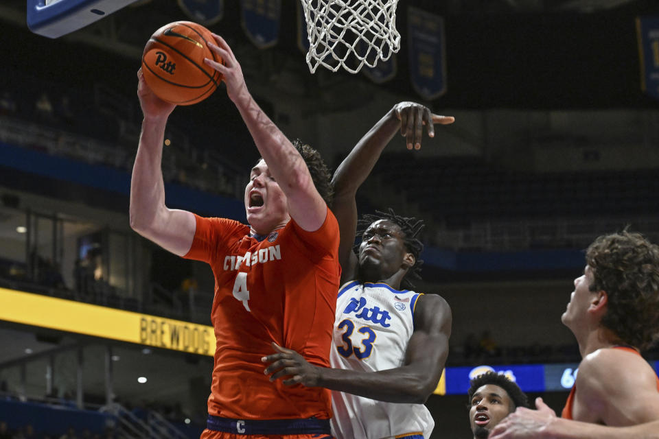 Clemson forward Ian Schieffelin (4) pulls down a rebound against Pittsburgh center Federiko Federiko (33) during the second half of an NCAA college basketball game, Sunday, Dec. 3, 2023, in Pittsburgh. (AP Photo/Barry Reeger)