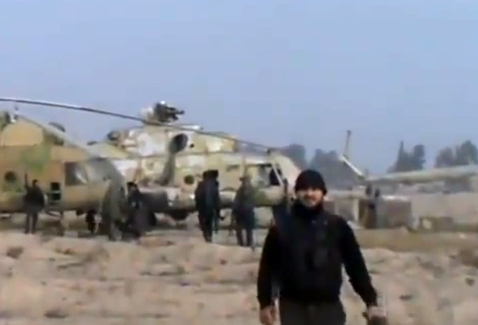 In this image taken from video obtained from the Ugarit News, which has been authenticated based on its contents and other AP reporting, Syrian rebels capture a helicopter air base near the capital Damascus after fierce fighting in Syria, on Sunday, Nov. 25, 2012. The takeover claim showed how rebels are advancing in the area of the capital, though they are badly outgunned by Assad’s forces, making inroads where Assad’s power was once unchallenged. Rebels have also been able to fire mortar rounds into Damascus recently. (AP Photo/Ugarit News via AP video)
