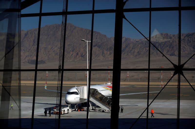 FILE PHOTO: A plane is reflected in the facade of the Ramon International Airport after an inauguration ceremony for the new airport, just outside the southern Red Sea resort city of Eilat, Israel