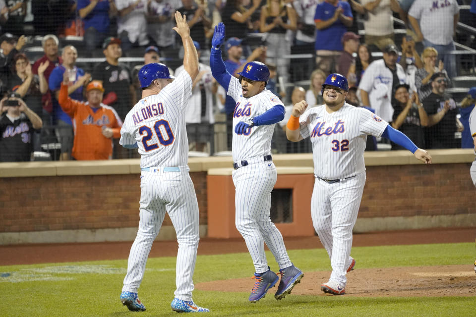 New York Mets' Eduardo Escobar, center, celebrates with Pete Alonso (20) and Daniel Vogelbach (32) after hitting a three-run home run during the second inning of a baseball game against the Pittsburgh Pirates, Saturday, Sept. 17, 2022, in New York. (AP Photo/Mary Altaffer)