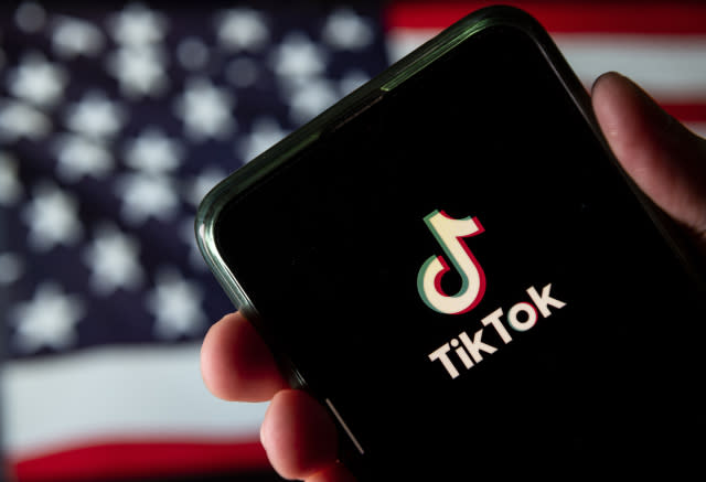 CHINA - 2020/08/11: In this photo illustration the Chinese video-sharing social networking service company, TikTok logo is seen on an Android mobile device with United States of America flag in the background. (Photo Illustration by Budrul Chukrut/SOPA Images/LightRocket via Getty Images)