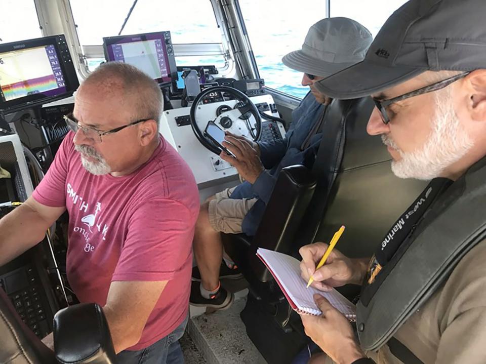 In this July 15, 2023, photo provided by Tamara Thomsen, Brendon Baillod, Bob Jaeck and Tom Crossmon survey the Trinidad off Algoma, Wisconsin. Baillod and Jaeck found the 156-year-old Trinidad in July 2023 off Algoma at a depth of about 270 feet ( They used side-scan sonar to hone in on its location based on survivor accounts in historical records.