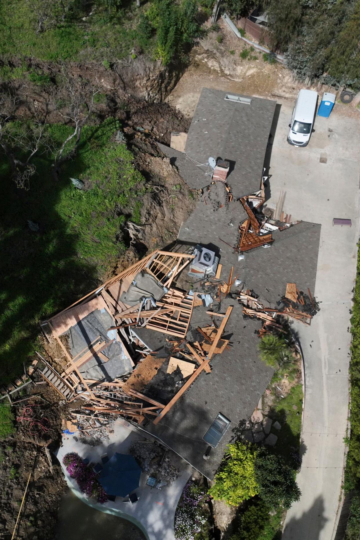 An aerial view shows a property damaged by a landslide, Wednesday, March 13, 2024, in the Sherman Oaks section of Los Angeles.