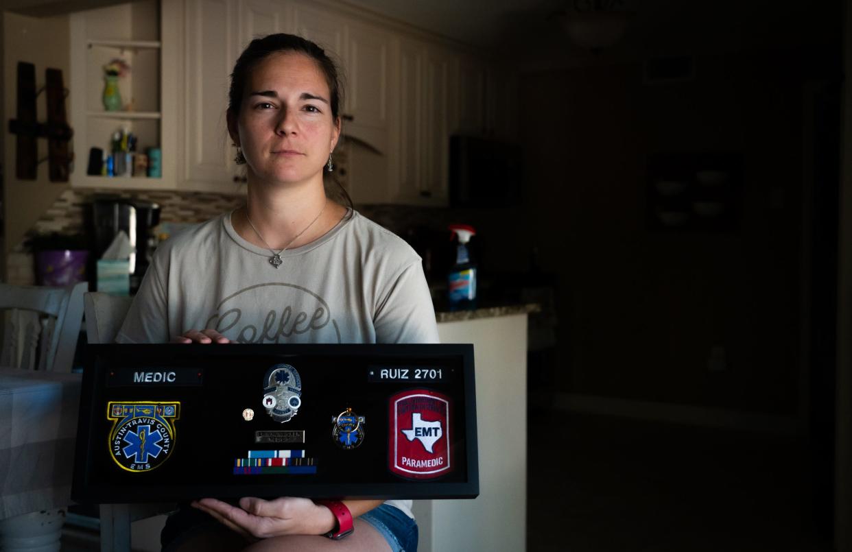 Erin Ruiz holds a shadow box with mementos from her time as an Austin-Travis County EMS paramedic on Wednesday in Waco. Ruiz, like nearly 78% of Austin's EMS force, lived outside of the city because of affordability. Eventually, she left the job.