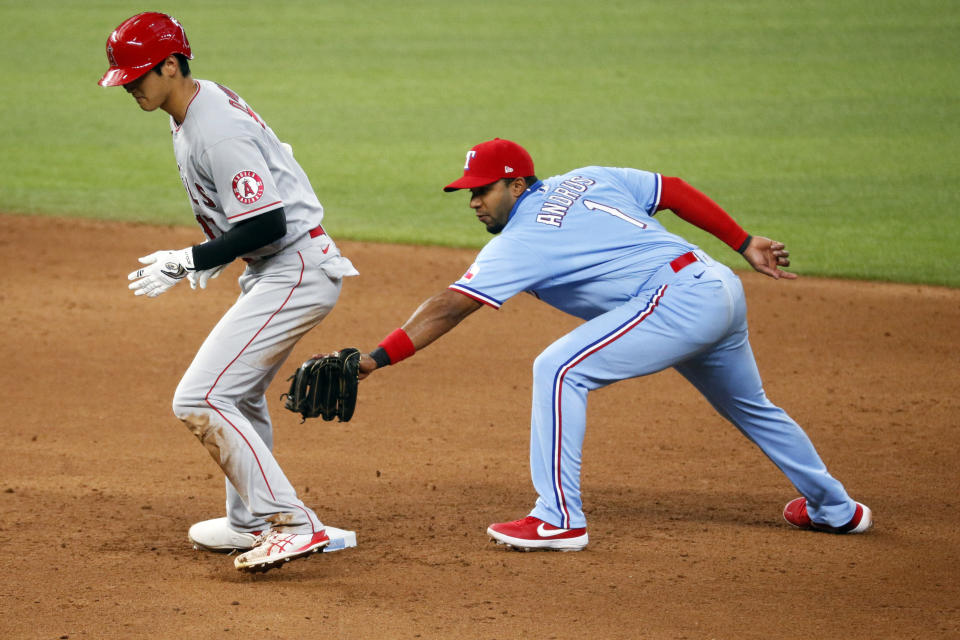 Los Angeles Angels' Shohei Ohtani, left, slides in safely at second base ahead of the tag by Texas Rangers shortstop Elvis Andrus, right, for a double in the sixth inning of a baseball game in Arlington, Texas, Sunday, Aug. 9, 2020. (AP Photo/Ray Carlin)