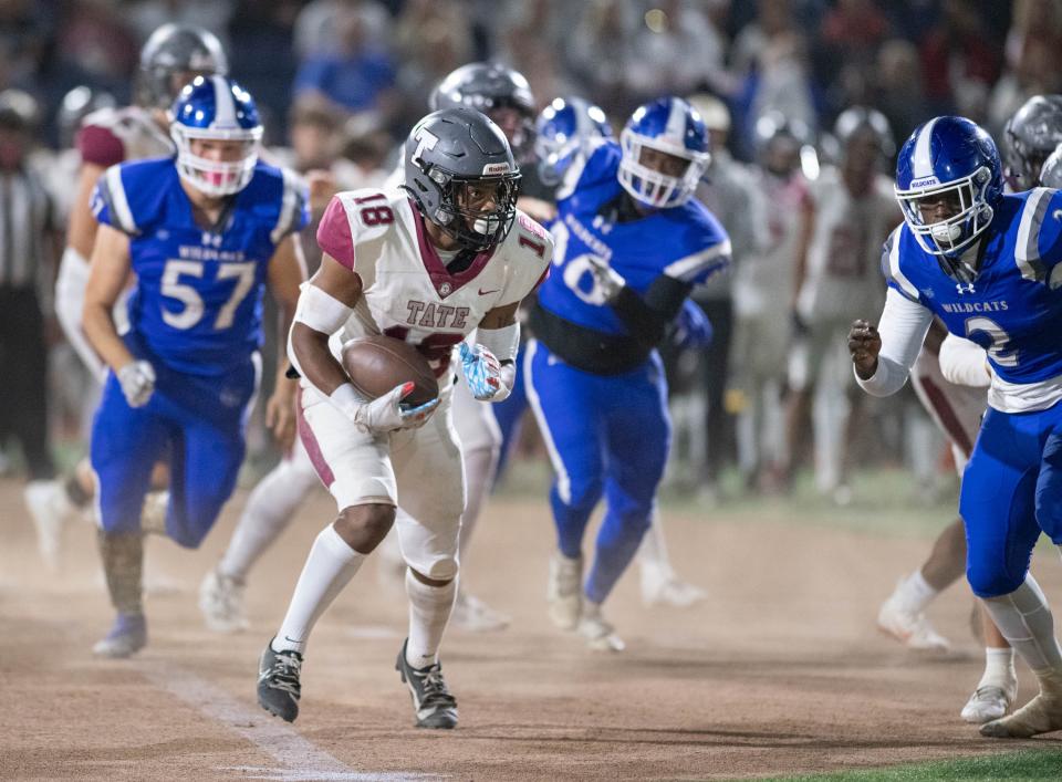 Andre Colston (18) carries the ball as the Tate High School Aggies take on the Booker T. Washington High School Wildcats in the inaugural First City Bowl football game at Blue Wahoos Stadium in Pensacola on Friday, Nov. 3, 2023.