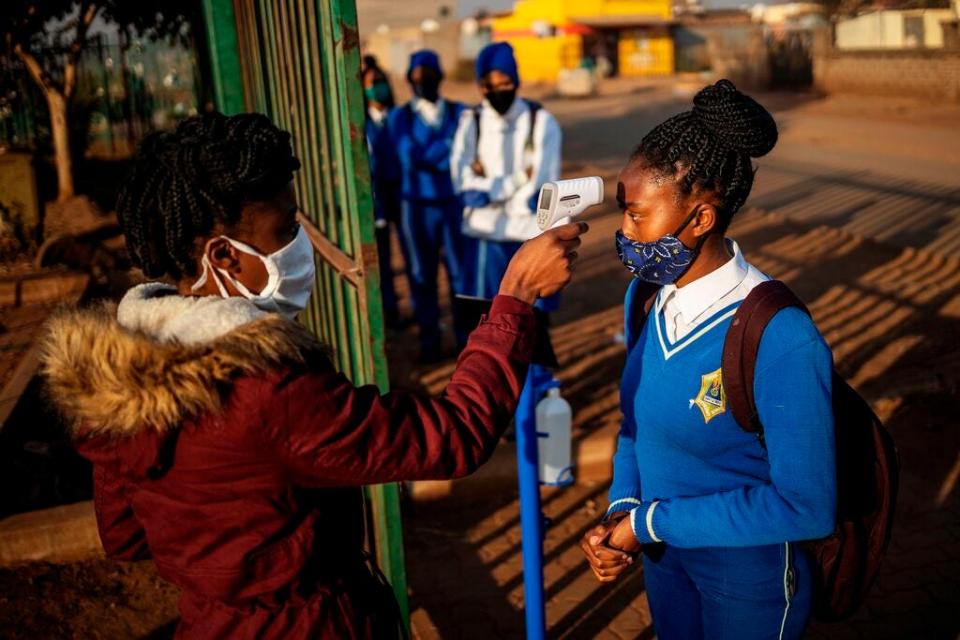 Checking students’ temperatures at the entrance of a school in the Tembisa township Ekurhuleni, South Africa, on June 8, 2020.