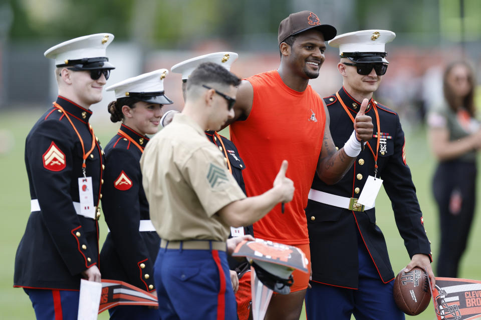Cleveland Browns quarterback Deshaun Watson poses for a photo with members of the military who were in attendance during NFL football practice at the team's training facility Wednesday, May 25, 2022, in Berea, Ohio. (AP Photo/Ron Schwane)