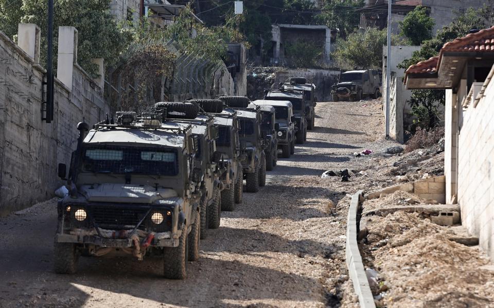Israeli military vehicles patrol in the Jenin refugee camp, in the occupied West Bank