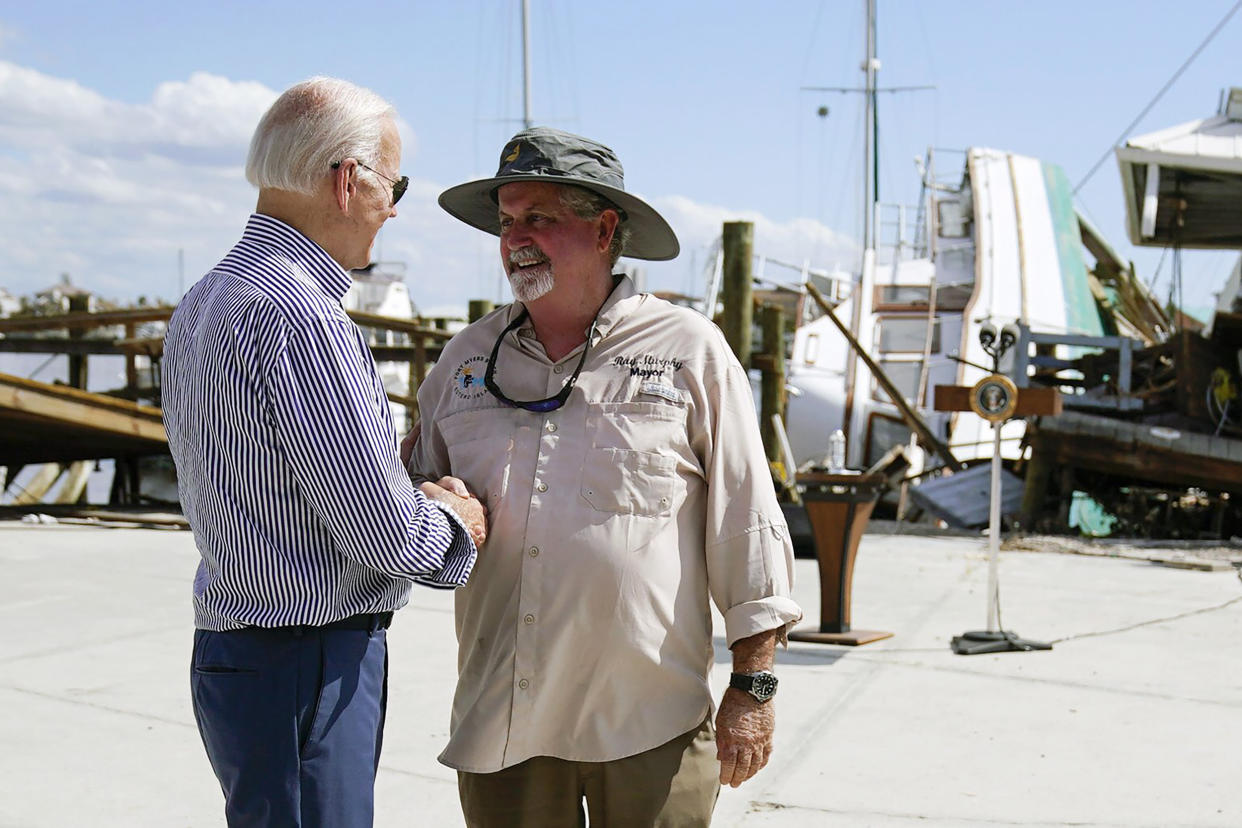 President Joe Biden shakes hands with Fort Myers Beach Mayor Ray Murphy as he tours the area impacted by Hurricane Ian, in Fort Myers Beach, Fla., on Wednesday, Oct. 5, 2022. (Evan Vucci / AP)