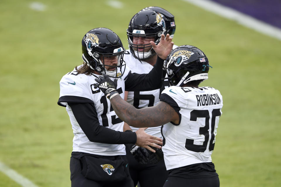 Jacksonville Jaguars quarterback Gardner Minshew II (15) and running back James Robinson (30) react after they connected for a touchdown pass against the Baltimore Ravens during the second half of an NFL football game, Sunday, Dec. 20, 2020, in Baltimore. (AP Photo/Gail Burton)