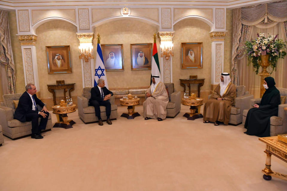 In this photo made available by the Israeli Government Press Office, In this photo made available by the Israeli Government Press Office, United Arab Emirates Minister of State Ahmed Ali Al Sayegh, center right, and Israeli Foreign Minister Yair Lapid, center left, speak during a meeting in Abu Dhabi, United Arab Emirates, Tuesday, June 29, 2021. Israel’s new foreign minister is in the UAE on the first high-level trip by an Israeli official to the Gulf Arab state since the two countries normalized relations last year. (Shlomi Amsalem/Government Press Office via AP)