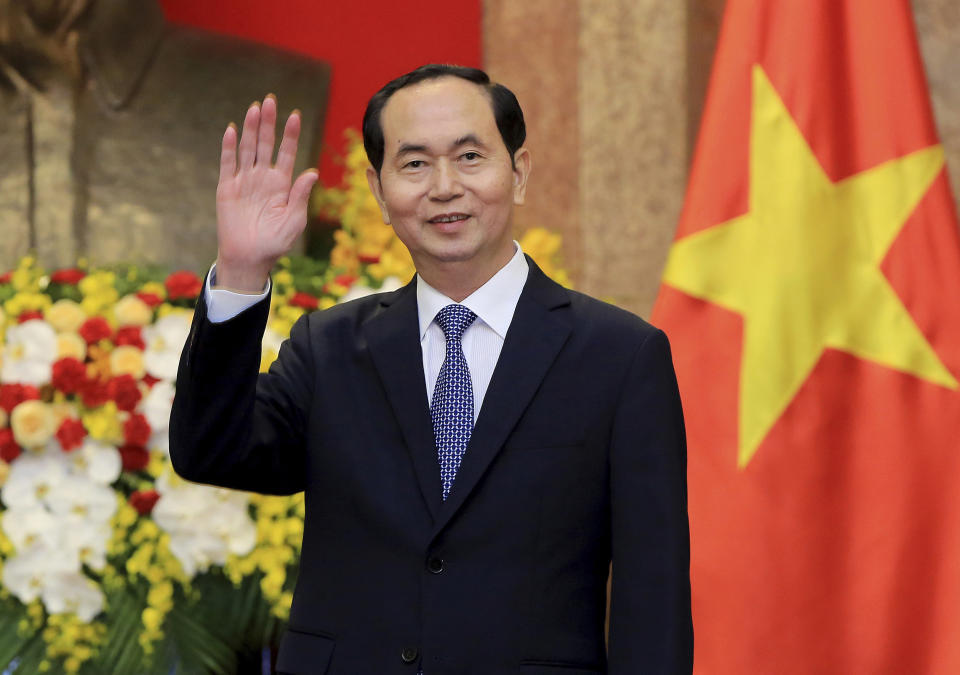 FILE - In this March 23, 2018, file photo, Vietnamese President Tran Dai Quang greets journalists as he waits for arrival of Russian Foreign Minister Sergei Lavrov at the Presidential Palace in Hanoi, Vietnam. Official media say Vietnamese President Tran Dai Quang has died at age 61 due to illness on Friday, Sept. 21, 2018. (AP Photo/Minh Hoang, Pool, File)