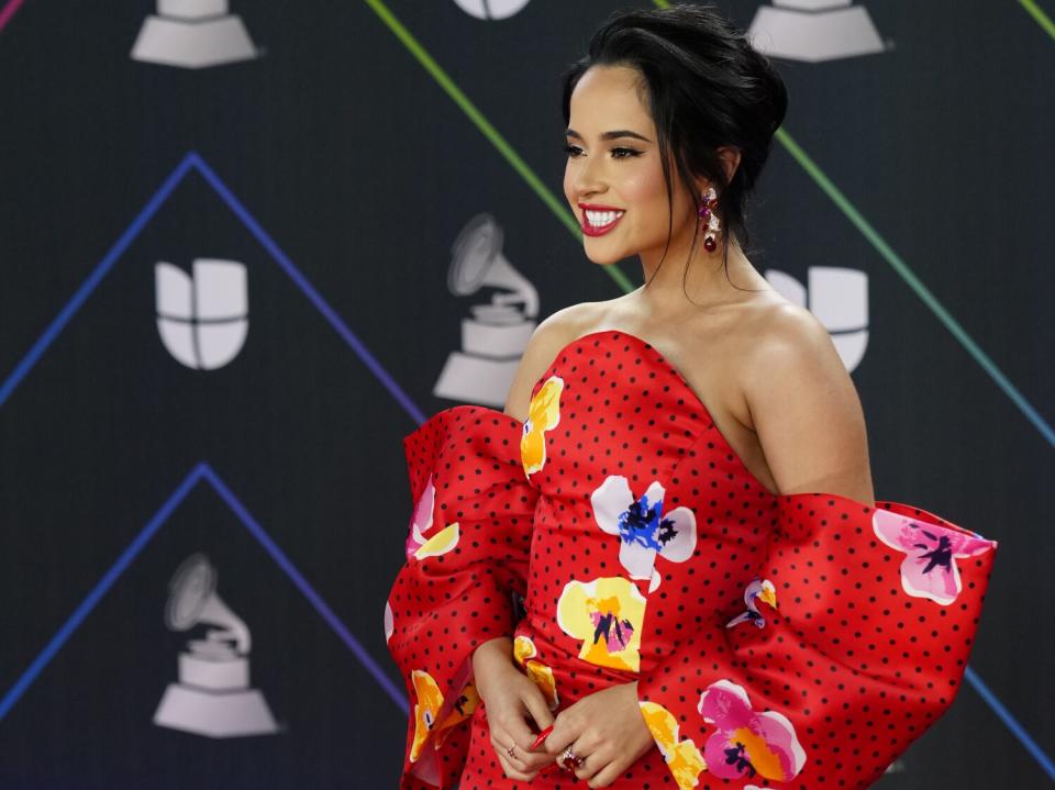 A woman in a floral red dress at an awards show