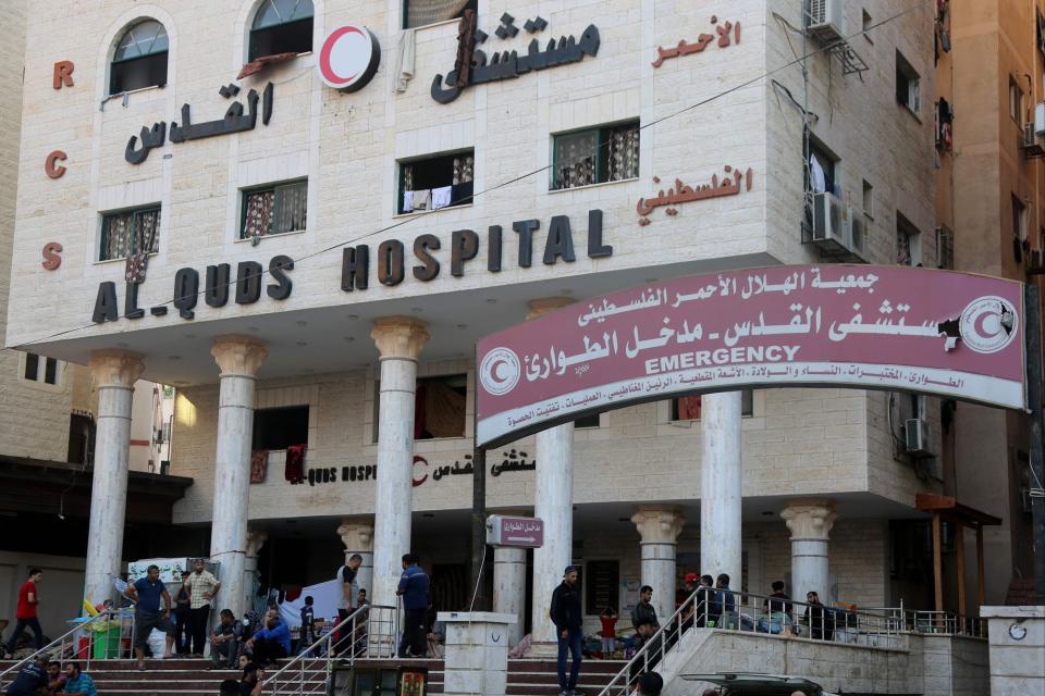 People wait outside Gaza City's Al-Quds Hospital on October 29 (AFP via Getty Images)