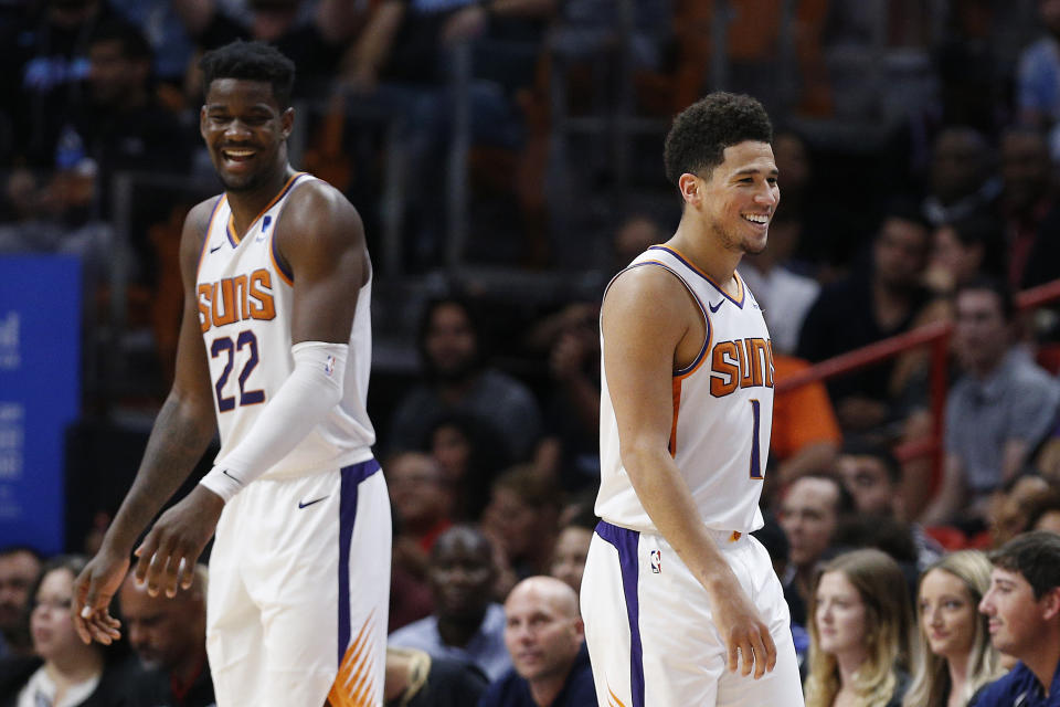 MIAMI, FLORIDA - FEBRUARY 25:  Devin Booker #1 and Deandre Ayton #22 of the Phoenix Suns react against the Miami Heat during the second half at American Airlines Arena on February 25, 2019 in Miami, Florida. NOTE TO USER: User expressly acknowledges and agrees that, by downloading and or using this photograph, User is consenting to the terms and conditions of the Getty Images License Agreement. (Photo by Michael Reaves/Getty Images)